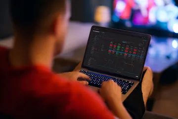 A close-up shot of golden coins falling around a spinning roulette wheel, representing immersive casino action at JILIX.
